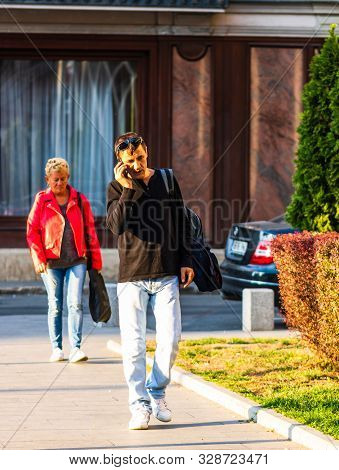 Tourists Walking On The Sidewalk Of Victoriei Way (calea Victoriei) In Bucharest, Romania, 2019