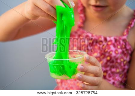 Hand Holding Homemade Toy Called Slime, Kids Having Fun And Being Creative By Science Experiment. Cl