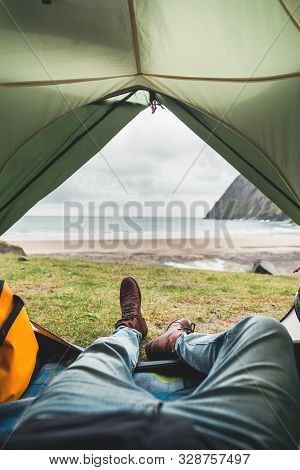 Active Traveler Inside Tent By The Sea And Great Mountains. Pov From Tent. Adventure Travel In Authe