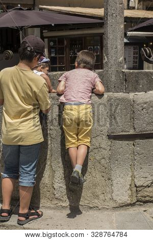 Carcassonne Languedoc-roussillon France - June 25, 2019: Children And Other Tourists Looking Down An