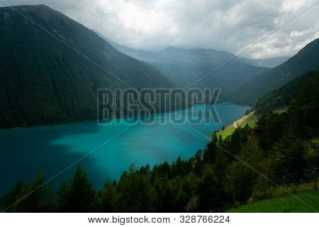 The Lake Vernagt-stausee (schnalstal, South Tyrol, Italy) On A Cloudy Day In Summer. The Water Of Th