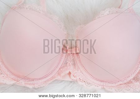 Detail Of Dlicate Pink Bodice With Lace On White Fur. Underwear, Fashion Concept. Close Up