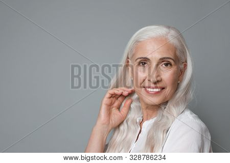 Portrait Of Beautiful Mature Woman On Grey Background, Space For Text