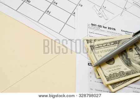 Irs Form 941-ss Employers Quarterly Federal Tax Return Blank Lies With Pen And Many Hundred Dollar B
