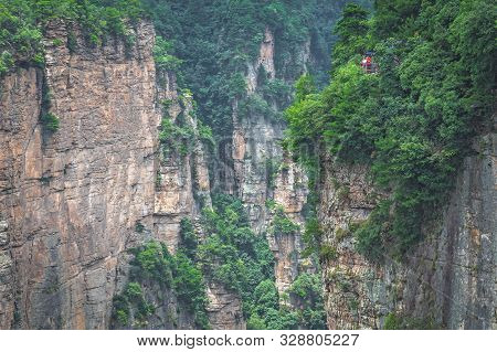 Tourists Taking Pictures On The Viewpoint Of The Greatest Natural Bridge Also Known As Tian Qiao Sky