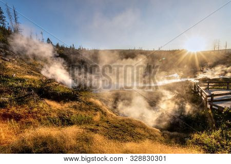 Sunset Over Artists Paintpot Trail As Steam Rises From The Geysers And Hot Springs At Yellowstone Na