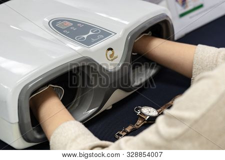 Woman Makes Cosmetology Procedure With Massage Apparatus - Hand Press Massage Machine Korean Flexi H