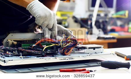 Repairman Detaches Power Supply Repairing Computer Monoblock In Workshop.