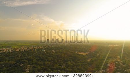 Aerial View Of Coal Power Plant -smoke From Factory Chimnys - Sunrise At Green Covered City With Fac