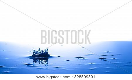 Splash Crown Shape Of Drop Water In Blue Tone, Blank Spce From Above To Create Concepttual.