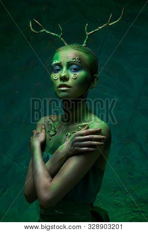 Girl With Deer Horns In Green Makeup