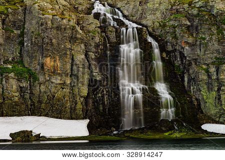 Mountain Lake Flotvatnet With Waterfall. Scenic Region Between Aurland And Laerdal In Norway. Nation