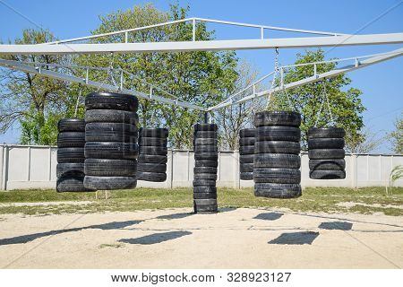 Homemade Punching Bags From Car Tires. Sports Ground In The Courtyard. Punching Bags