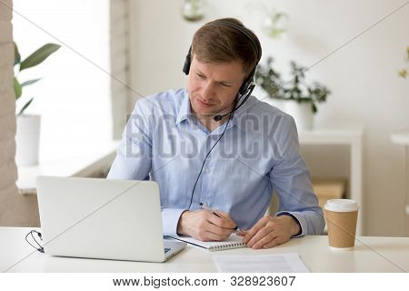 Concentrated Pleasant Successful Male Entrepreneur Watching Educational Webinar.