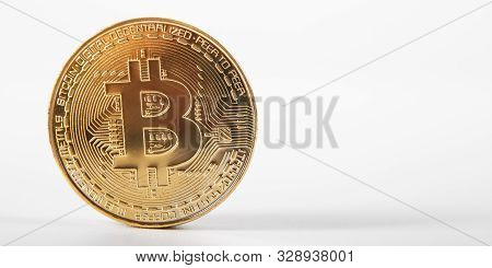 Golden Bitcoin On Isolated On White Table. A Visual Representation Of Digital Cryptocurrencies. Bitc