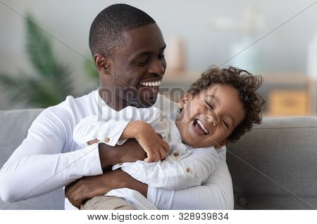 Happy Ethnic Dad And Little Son Have Fun At Home