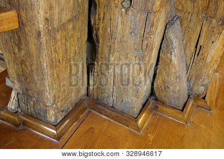 Massive Wooden Supports In The Structure Of The Old Building. Old Wood, Impregnated With Varnish. Su