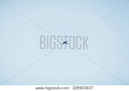 Small Private Plane Flying In The Blue Sky