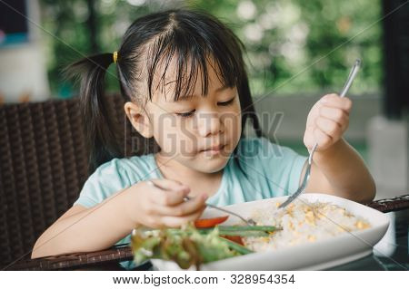 Asian Kids Eating Food And Drink By Herself. Confidence And Self Esteem Can Develop From Self-help I