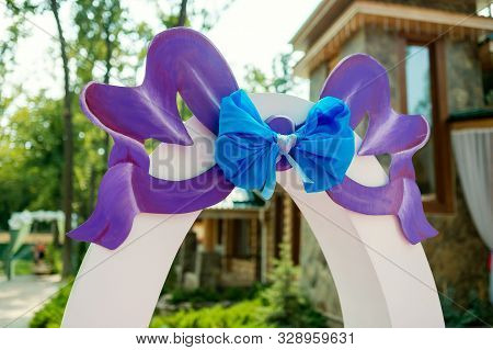Wedding Decor Concept. Wooden Letters With A Baw And A Ribbon. Closeup.