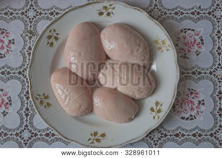 Lamb Eggs Peeled From The Shell And Prepared For Cooking Lie On A Beautiful Plate On The Table.