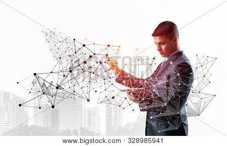 Business Person Pointing On Abstract Network Structure. Standing Personal Assistant In Business Suit