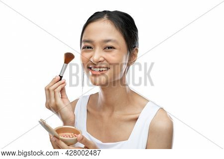 Smiling Asian Woman Wearing Underdress Applying Make Up With Brush