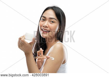 Smiling Asian Woman Wearing White Underdress Using Body Cream Rub Into Arm