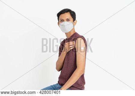 Proud Asian Male Patient Getting Vaccinated Against Coronavirus