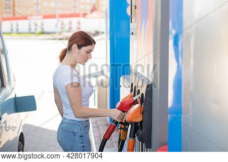 Caucasian Woman Refueling A Car At A Self-service Gas Station.