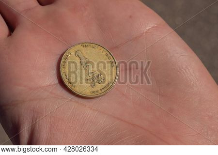 Modern Israeli Coin In The Hand. 0, 5 Sheqel. High Quality Photo