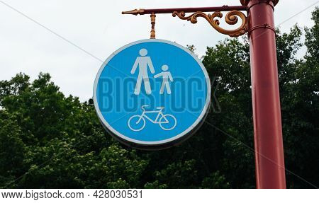 Road Sign On The Post. Walking And Cycling Area. Bicycle And Pedestrian Lane Road Sign On Pole Post,