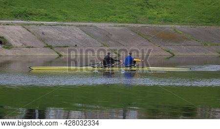 Kyiv Ukraine, The Dnieper River - May 02 2021: Two Unknown Young Athletes Are Sailing In A Two-seate