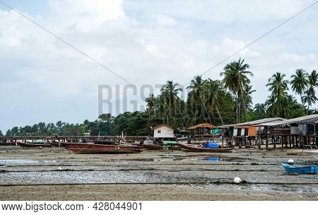 Fisherman's Fishing Boat On Sand At A Fishing Village Beach,stranded Fishing Boat After The Sea Has 
