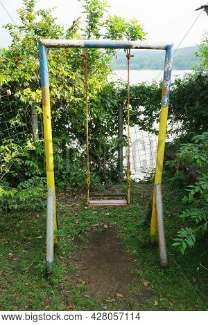 Swing Made Of Iron In The Corner Of The Garden