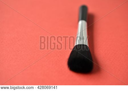 Brush For Cleaning Optics On A Red Background