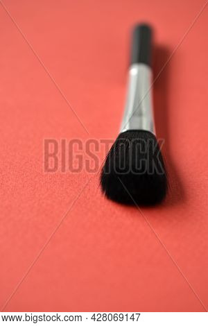 Brush For Cleaning Optics On A Red Background