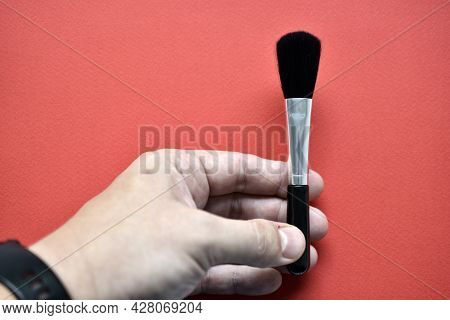 Brush For Cleaning Optics On A Red Background