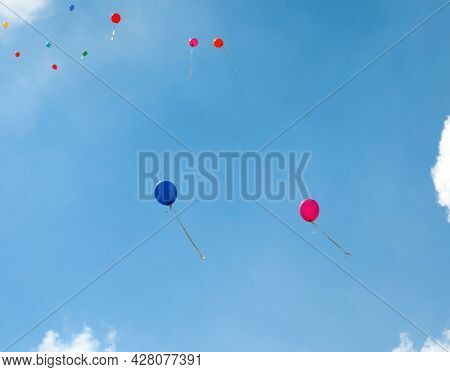 Two Balloons Blue And Red Flight In The Sky During The Party