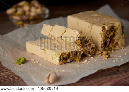 Organic Halva With Pistachios On A Wooden Surface. Traditional Middle Eastern Sweets. Jewish, turkis
