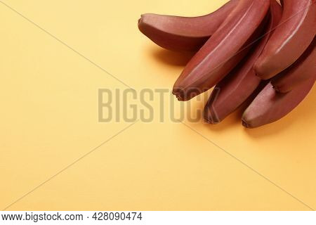 Tasty Red Baby Bananas On Yellow Background, Top View. Space For Text