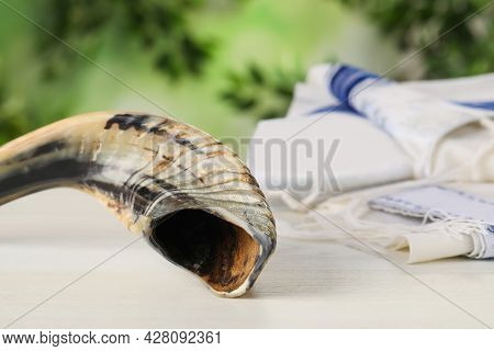 Shofar And Tallit On White Wooden Table, Space For Text. Rosh Hashanah Holiday Attributes