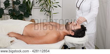 Acupuncture Treatment To Relieve Stress And Relax The Body Man. Male Patient Lying Down While Having