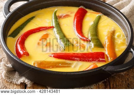 National Dish Of Bhutan Ema Datshi Closeup In The Pan On The Table. Horizontal