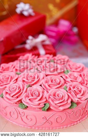 Docorated On Cake And Gift Boxes In Background