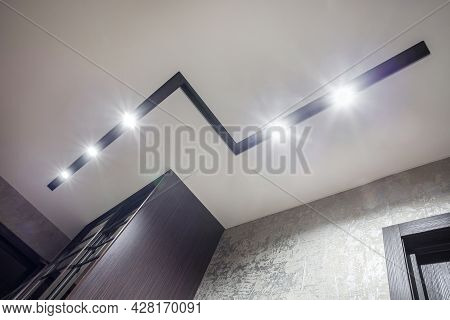 Suspended Ceiling With Halogen Spots Lamps And Drywall Construction In Empty Room In Apartment Or Ho