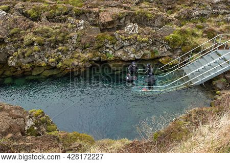 Silfra, Iceland - May 20, 2019: Scuba Divers And Snorkelers Preparing Entering In The Water At Silfr