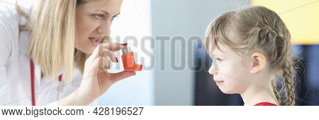 Pulmonologist Doctor Holding Hormonal Inhaler In Front Of Little Girl