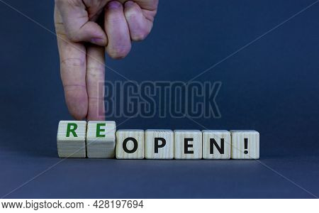 Open Or Reopen Symbol. Businessman Turns Wooden Cubes And Changes The Word 'open' To 'reopen'. Beaut