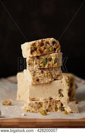 Organic Halva With Pistachios On A Wooden Surface. Traditional Middle Eastern Sweets. Jewish, turkis